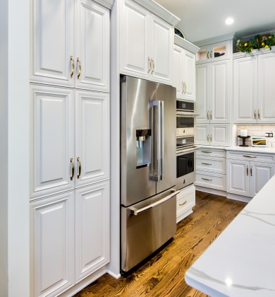 Custom white kitchen cabinets around fridge in Naperville IL