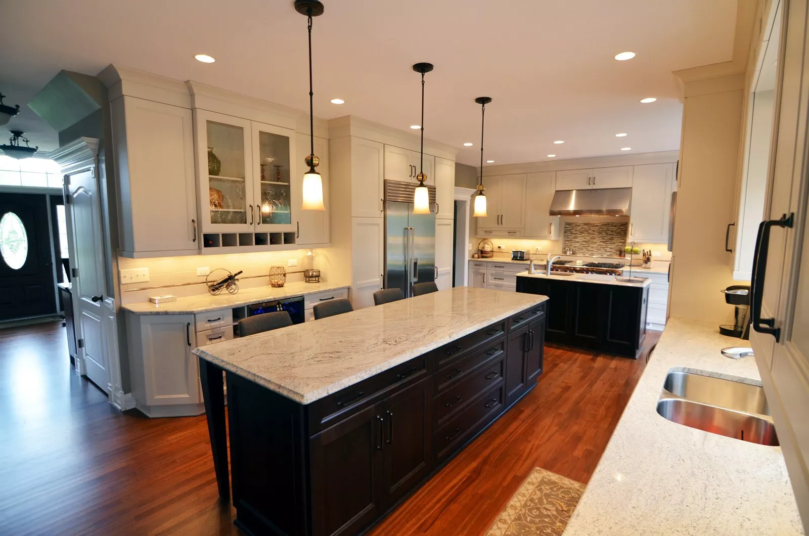 the kitchen master renovation dark cabinets light quartz countertops pendant lighting large island
