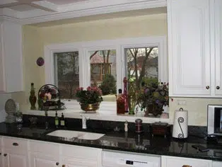 Sink area in cookie cutter white kitchen.