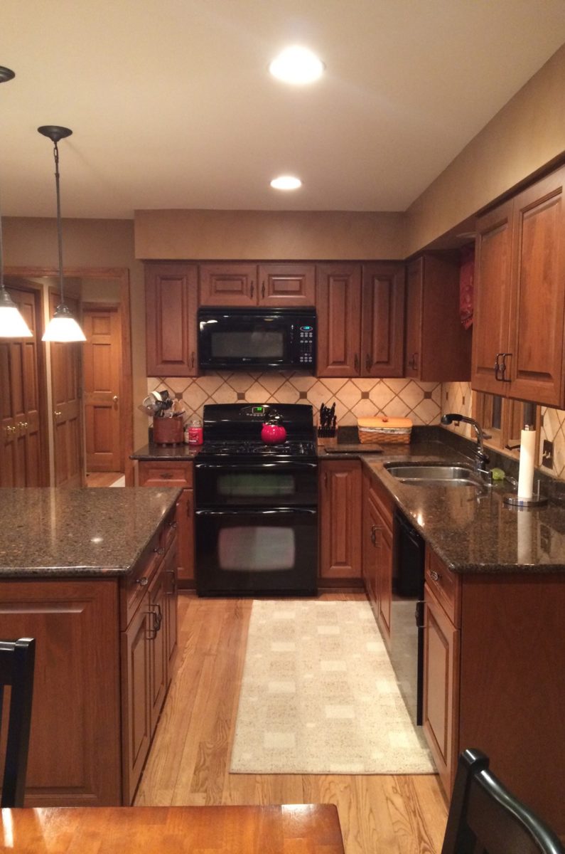 the kitchen master traditional renovation deep redwood cabinets black appliances