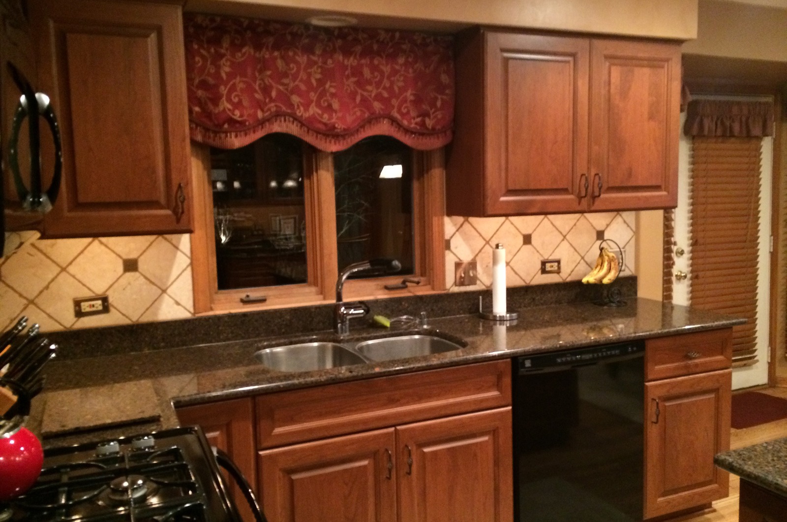 the kitchen master renovation traditional patterned backsplash redwood cabinets black appliances