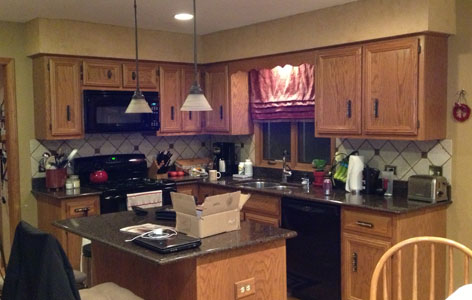 the kitchen master before remodel light cabinets black appliances pendant lighting over island