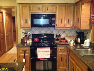 the kitchen master before renovation black appliances light cabinets traditional