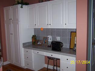 Unused desk and pantry before kitchen redesign.