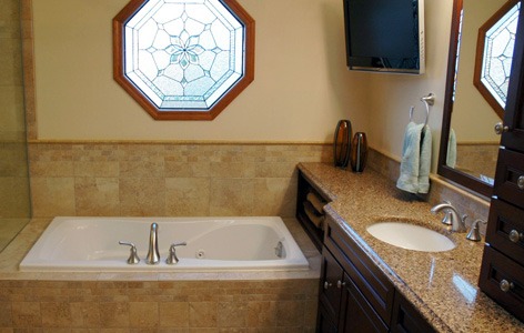 Bathroom remodeling in Naperville, IL. Warm bath area with open towel storage area and TV.