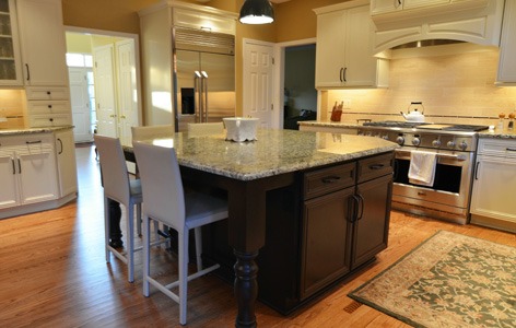 Kitchen remodeling in Naperville, IL. Dark kitchen island and stained hardwood flooring.