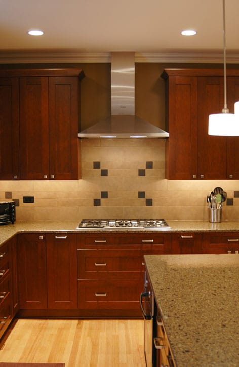 Kitchen remodeling in Naperville, IL. Chimney hood and decorative tile for kitchen.