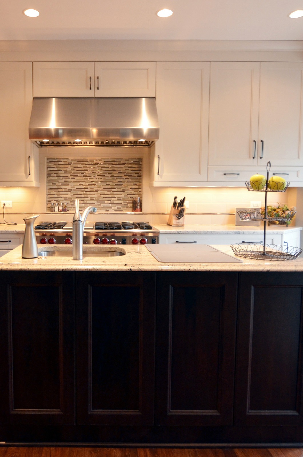 the kitchen master remodel white overhead cabinets dark floor cabinets hooded vent recess lighting