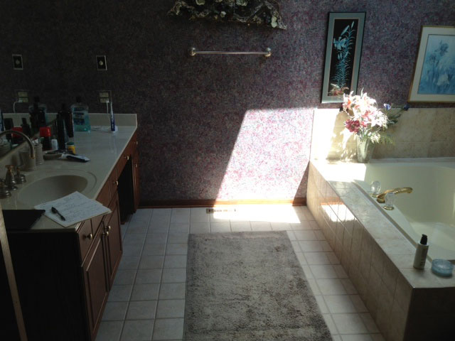 Second vanity area with old tub space that became a shower following remodeling. Bathroom remodeling in Naperville, IL.