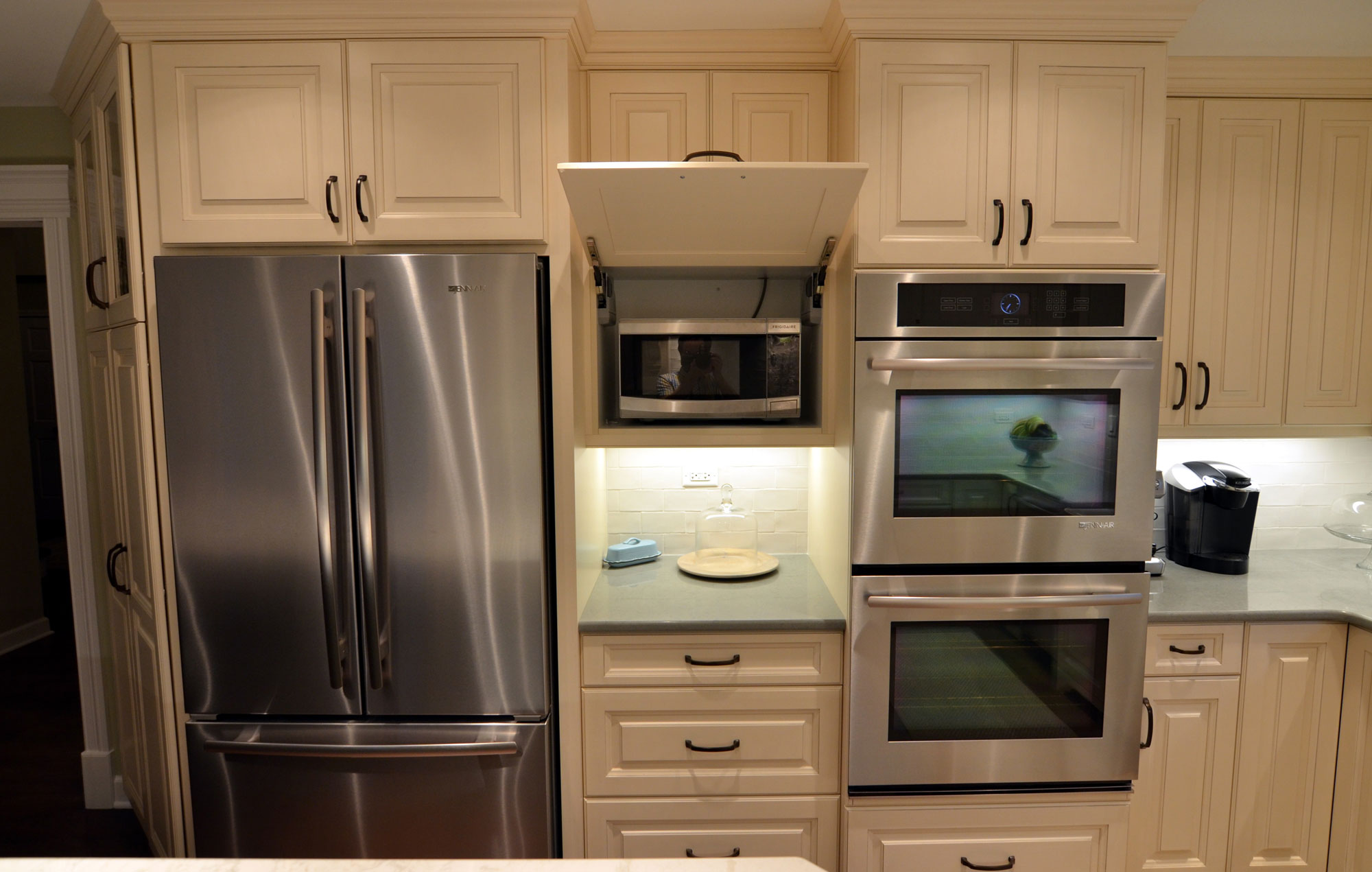 Kitchen remodeling in Naperville, IL. Kitchen ovens, microwave and refrigerator following redesign.