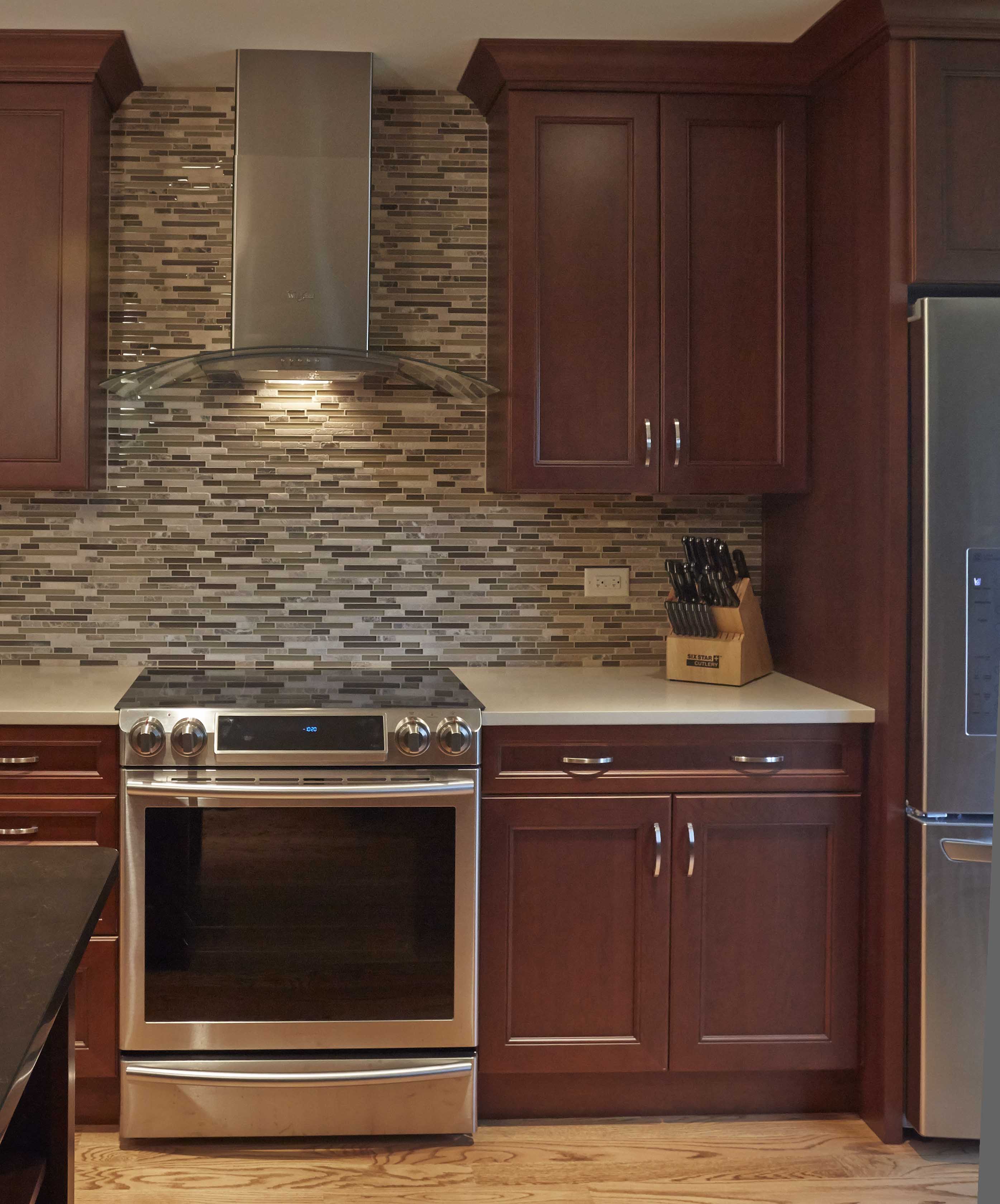 home kitchen oven with canopy and custom cabinets