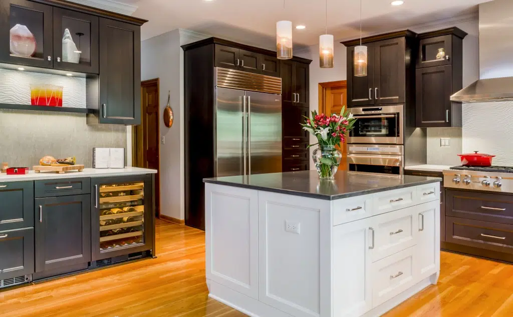 kitchen renovation black and white cabinetry cylinder lighting over island wine fridge hooded vent