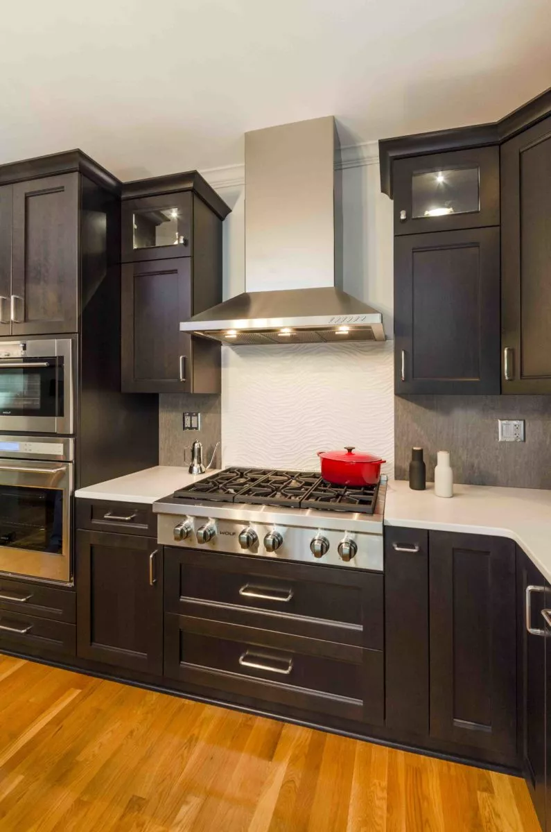 the kitchen master remodel deep brown cabinets hooded vent over gas range hardwood floors