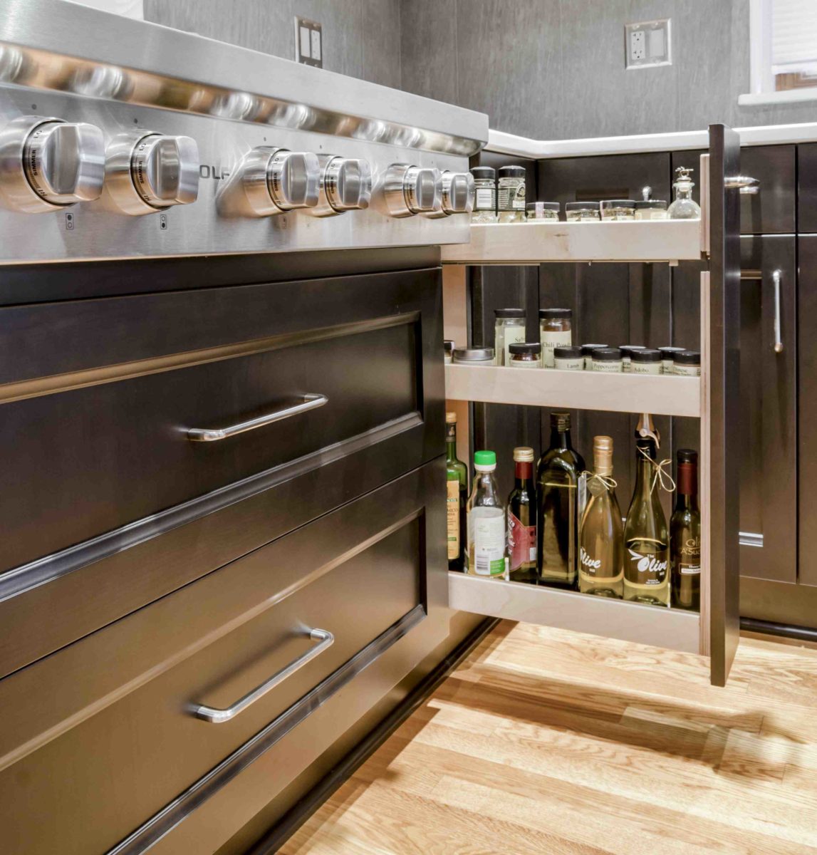 the kitchen master remodel spice drawer gas range dark cabinets light hardwood floors