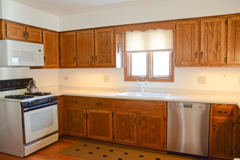 the kitchen master before remodel white stove oak cabinetry white microwave