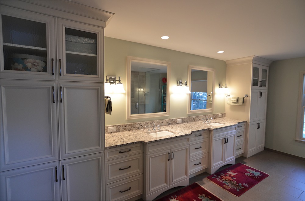 bathroom renovation white wall cabinets with vanity between double sink and mirror