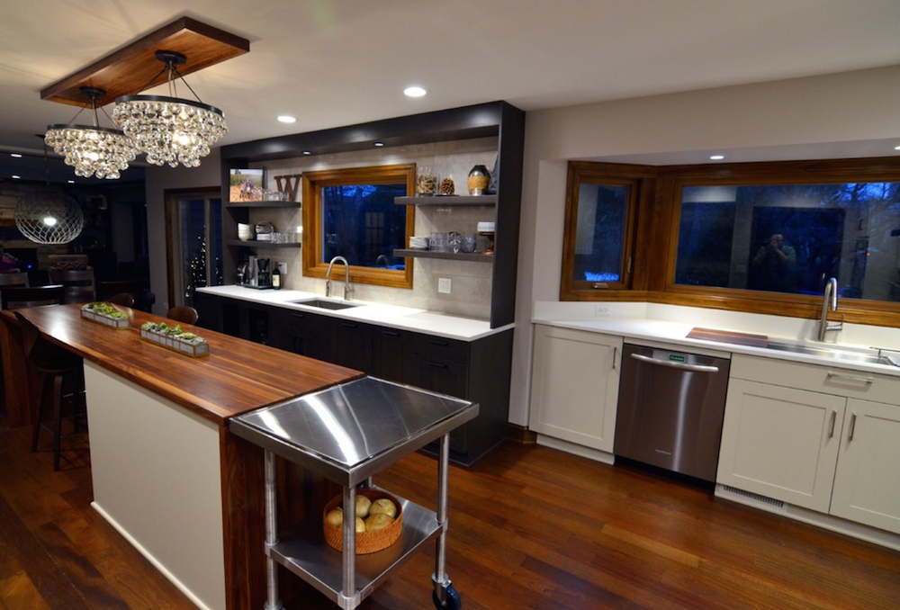 kitchen remodel contrast colors hardwood flooring white cabinetry open shelving chandelier lighting