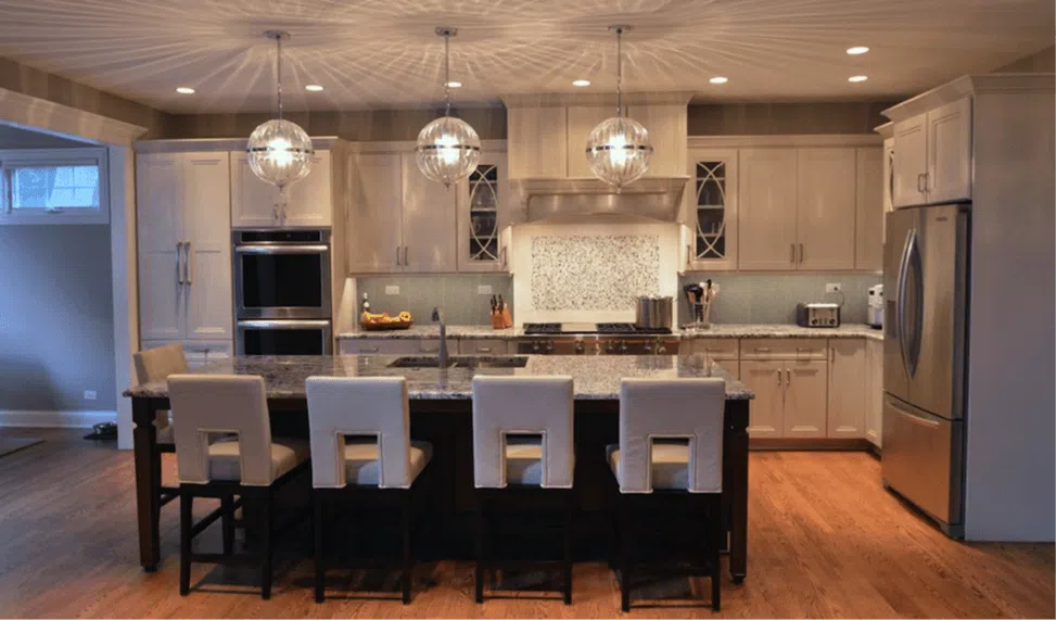 elegang kitchen remodel globe pendant lighting over granite island white cabinetry stainless steel