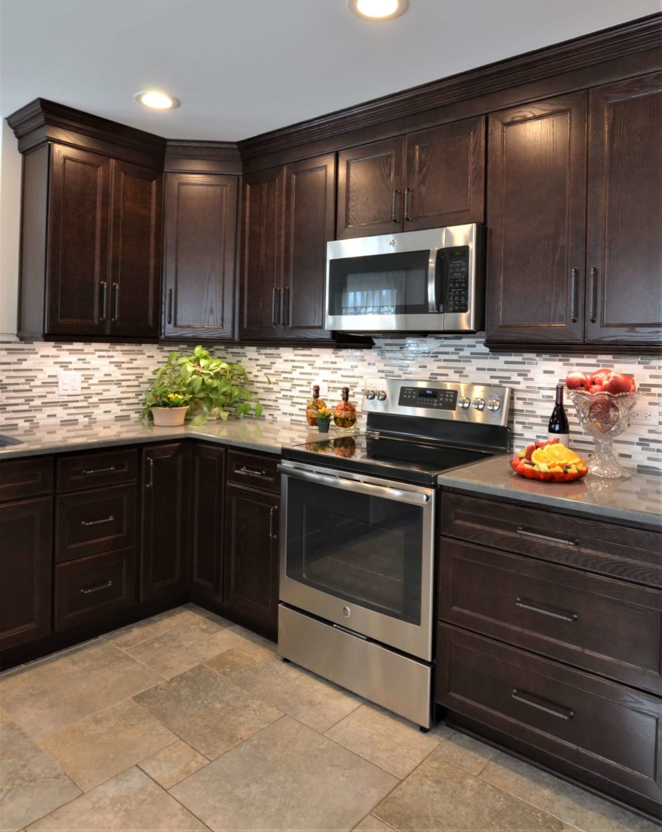 Kitchen counter with oven, electric stove, microwave, drawers, and cabinets