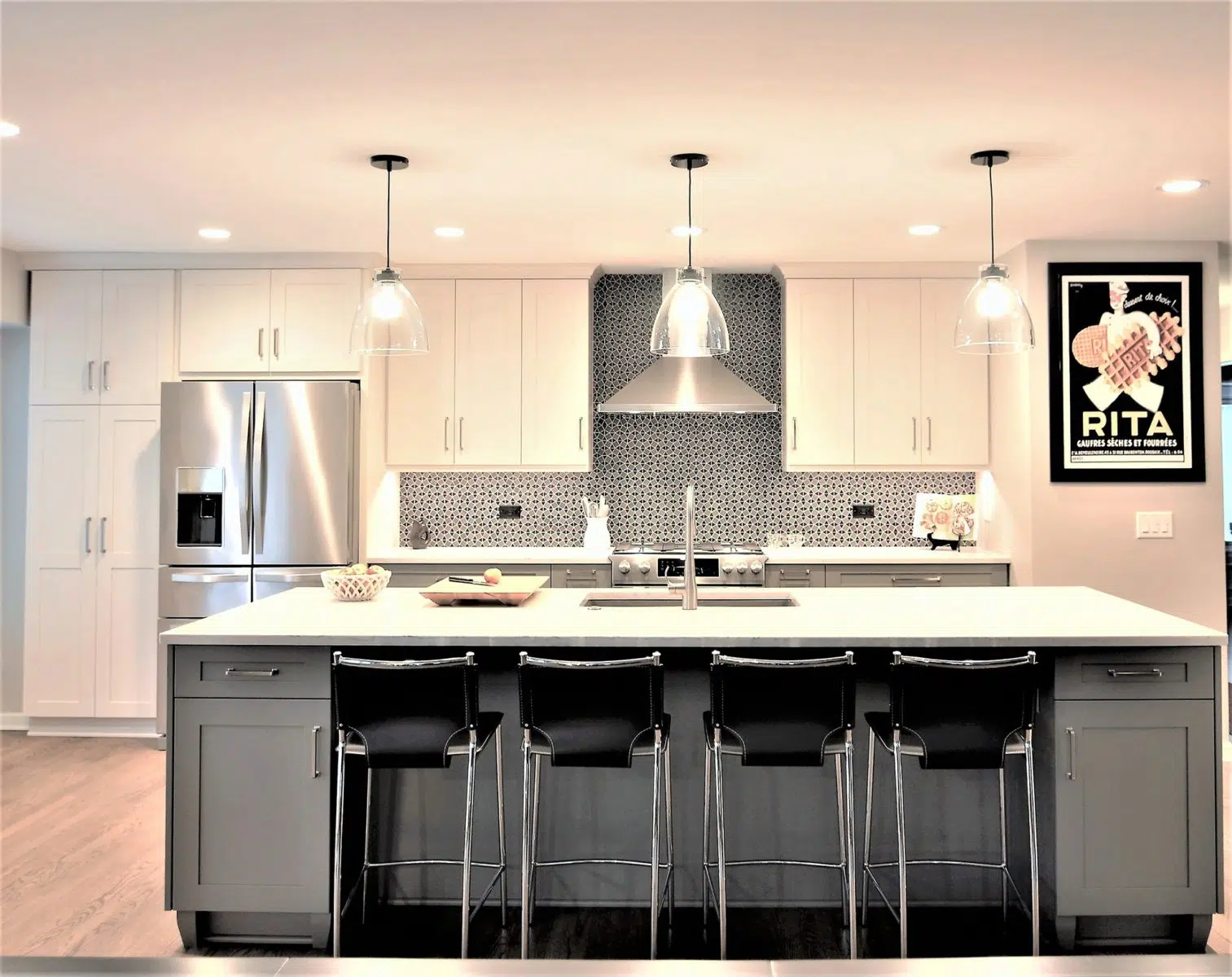 bright kitchen renovation white and grey cabinetry stainless steel appliances hooded vent