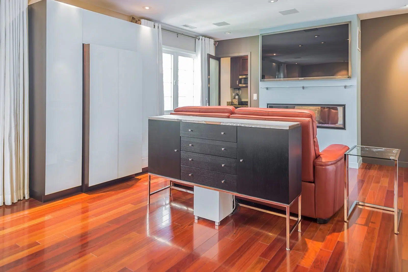 living room renovation hardwood floors hidden storage orange recliner mounted flatscreen