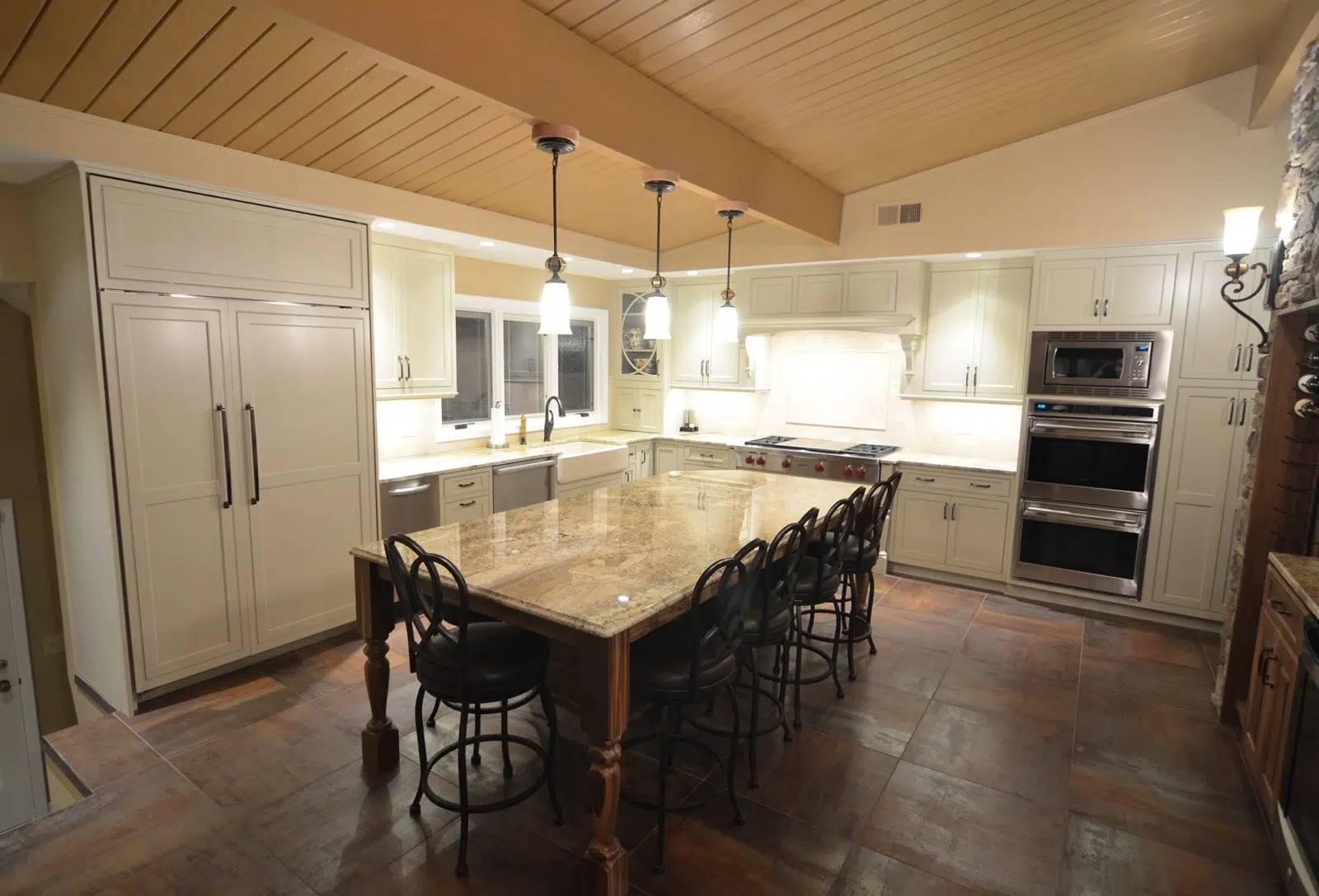 Kitchen with cabinets, drawers, sink, appliances, windows, polished stone kitchen table with chairs