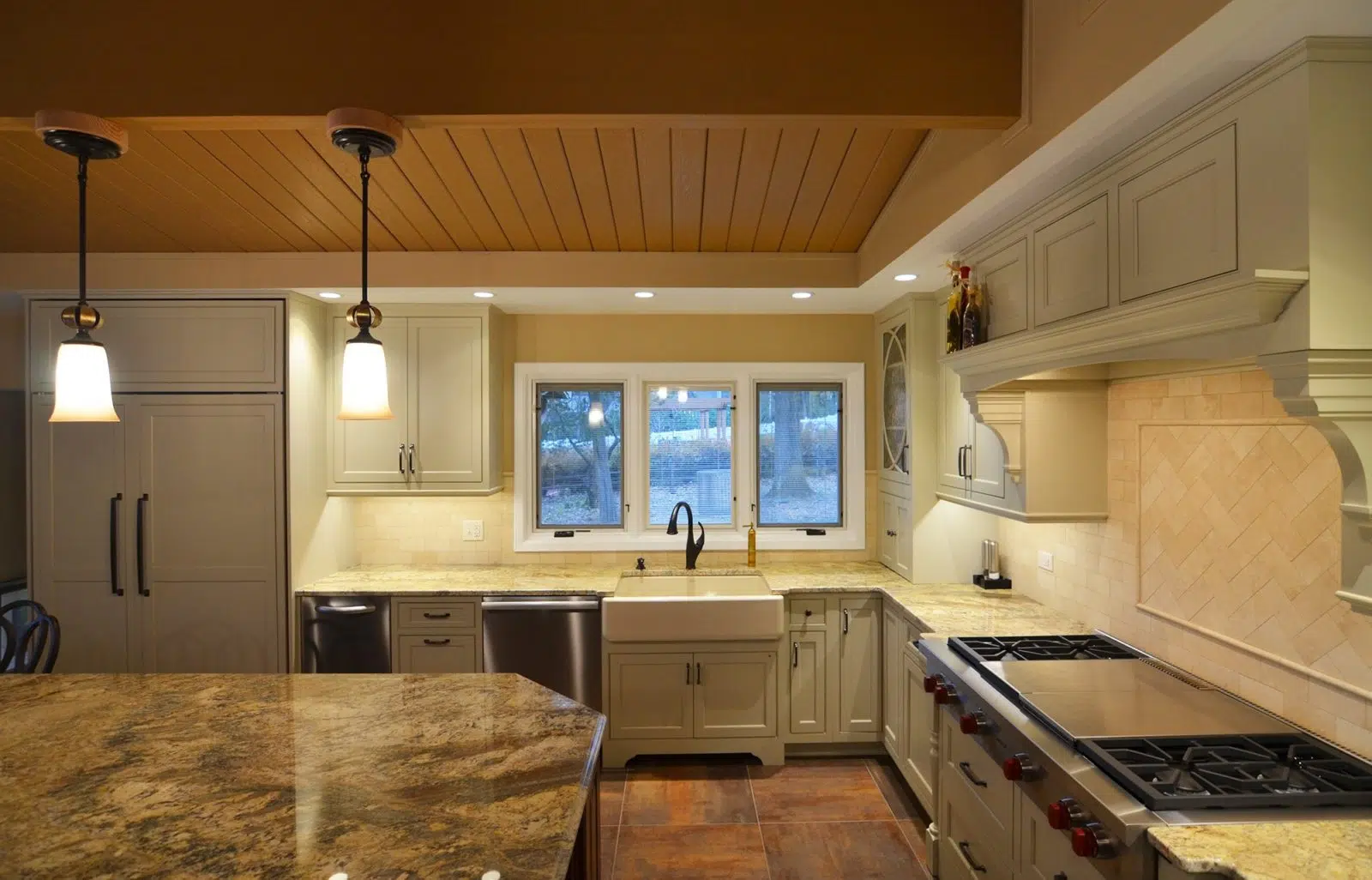 Kitchen with cabinets, drawers, sink, appliances, windows, polished stone kitchen table with chairs