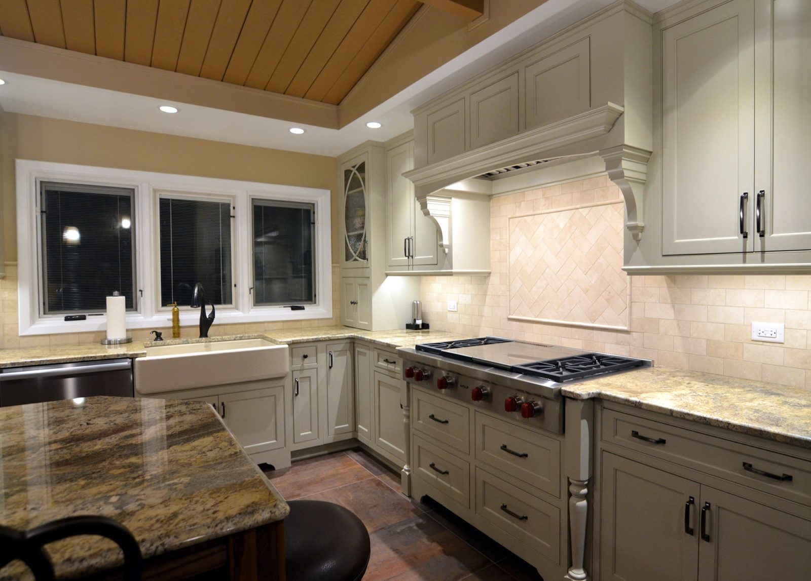 Kitchen with cabinets, drawers, sink, appliances, windows, polished stone kitchen table with chairs