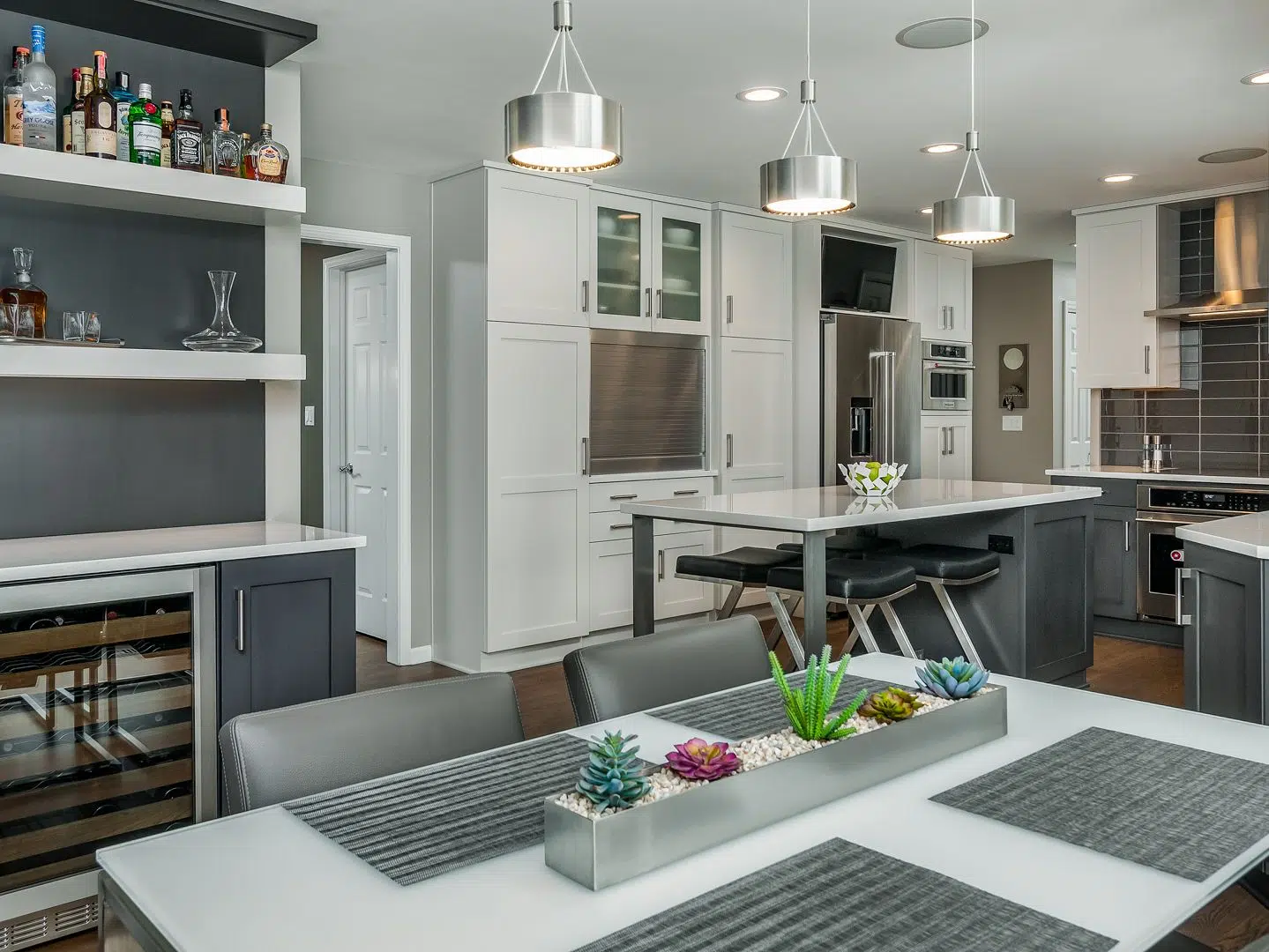 Modern kitchen and dining room with table, chairs, island, and appliances