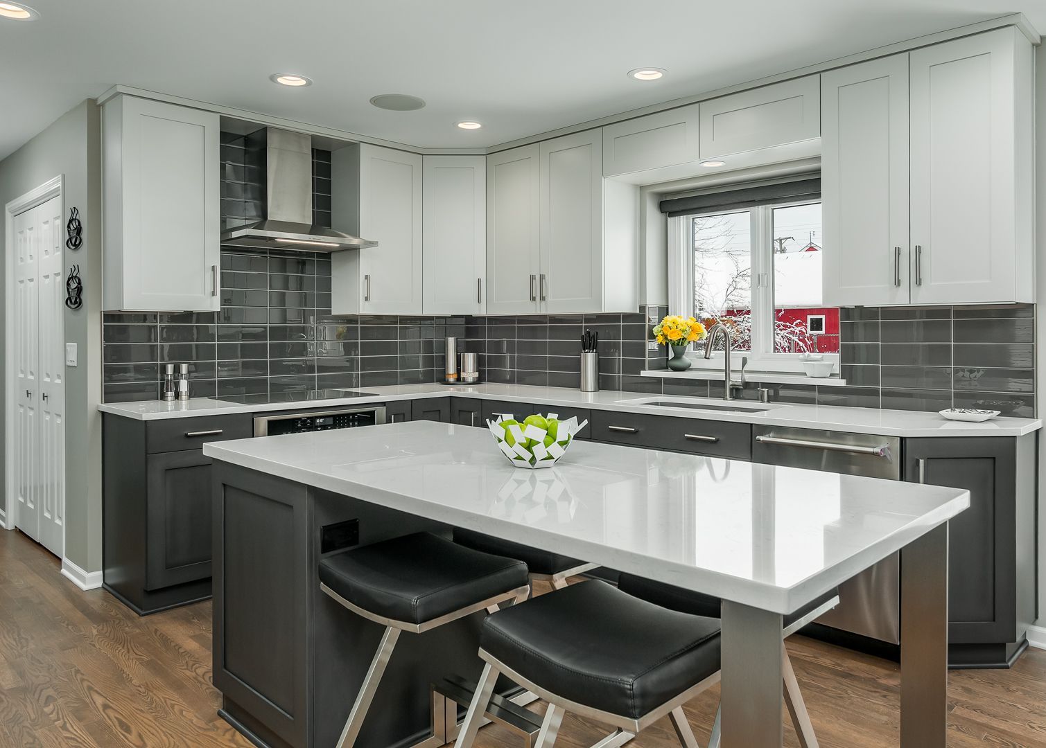 Modern kitchen with island, drawers, cabinets, appliances, sink, and polished stone countertops