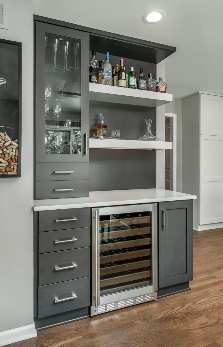 Kitchen with wine cooler, cabinets and drawers stocked with glasses and alcohol