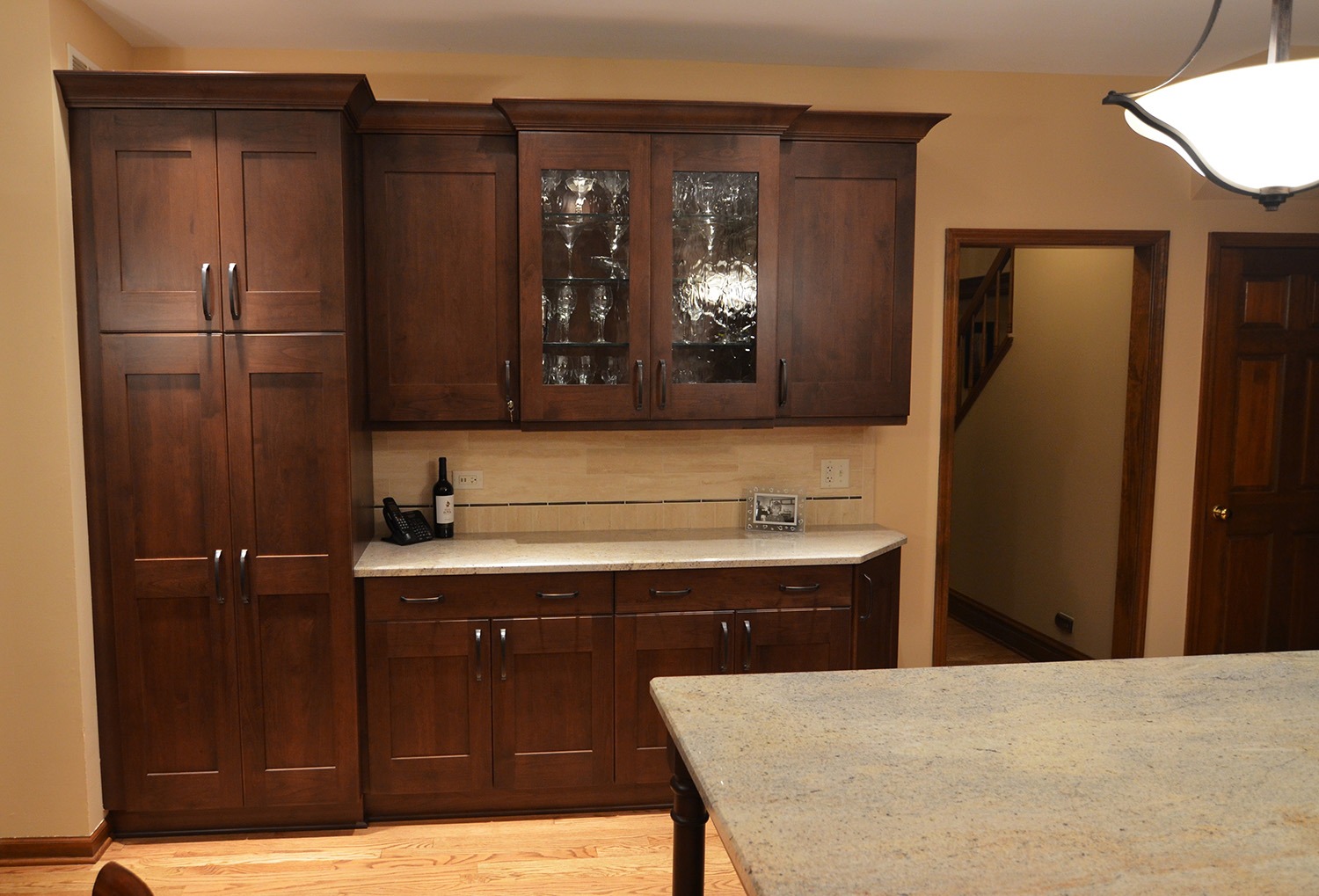 Kitchen with island, cabinets, drawers, and polished stone countertops
