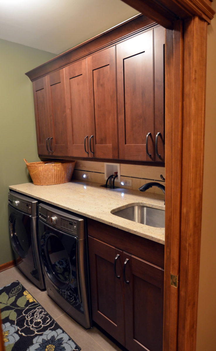Laundry room with sink, countertops, cabinets, washer and drier
