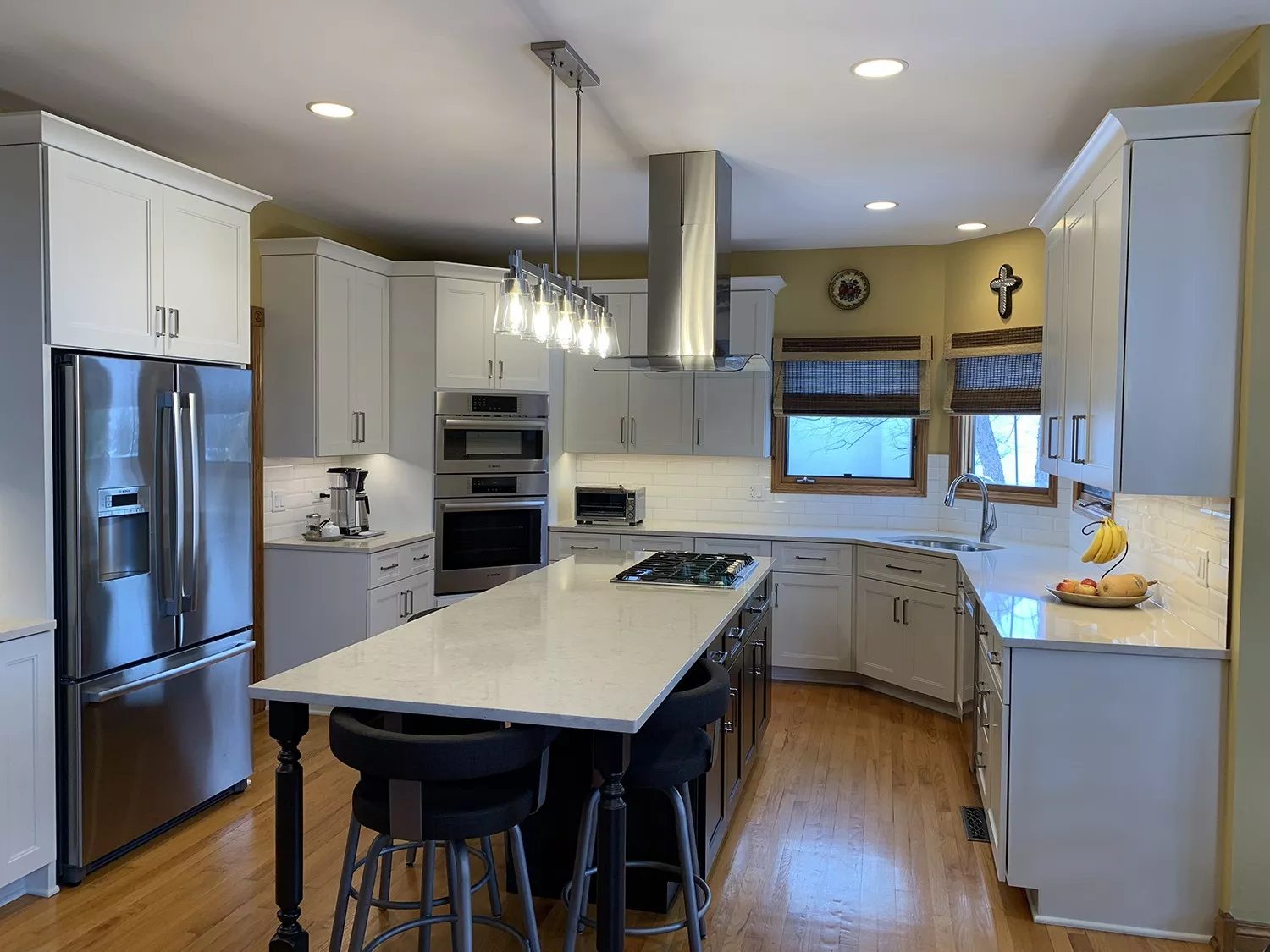 Kitchen with sink, cabinets, drawers, appliances, and an island with a built-in stovetop