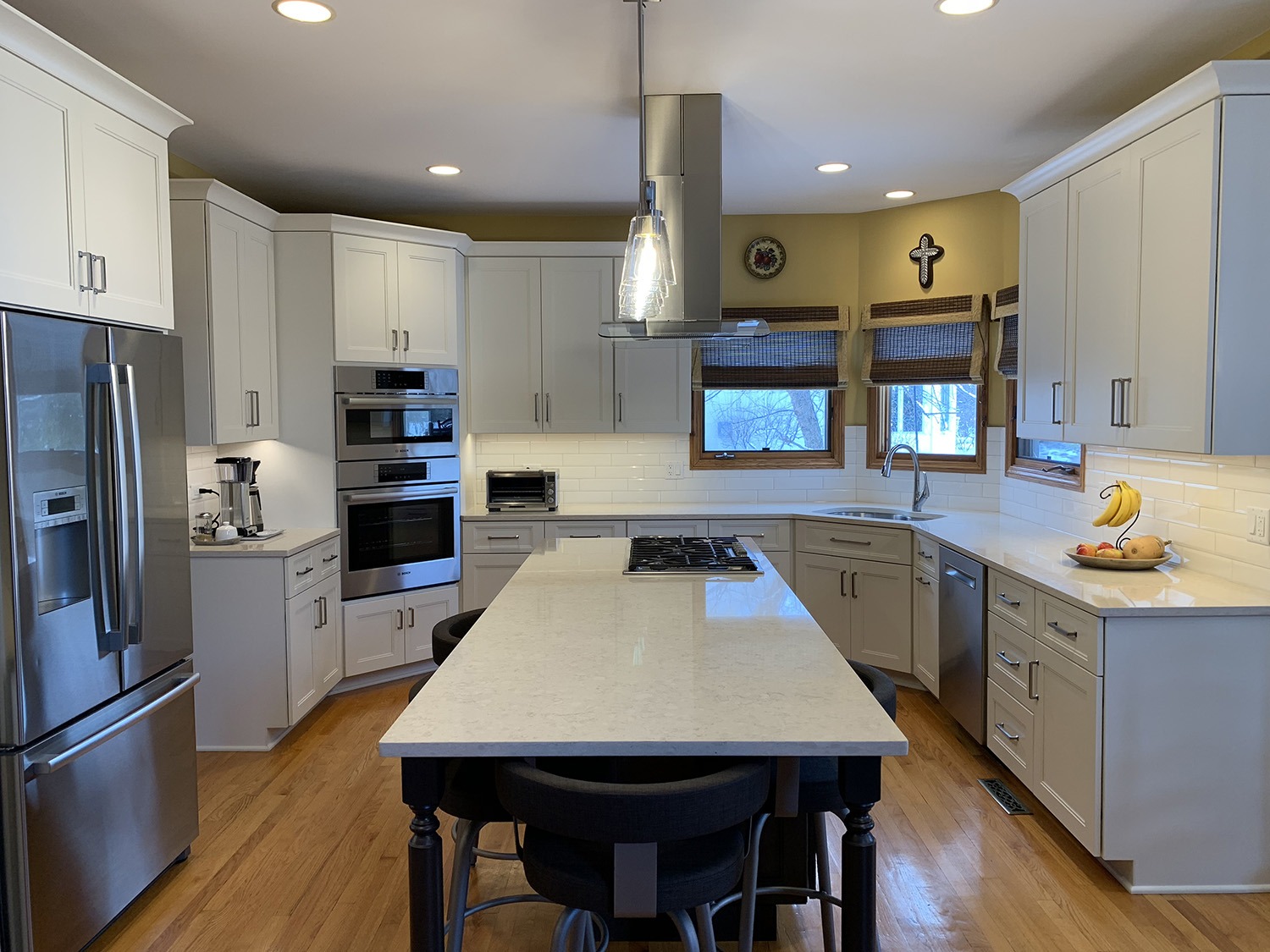 kitchen remodel long white island with stovetop and vent stainless steel recess lighting chrome hardware