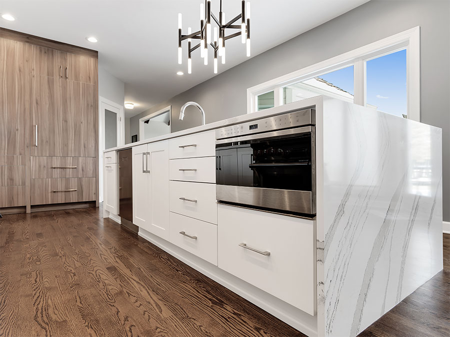 Large island with drawers, cabinets and appliances in a kitchen