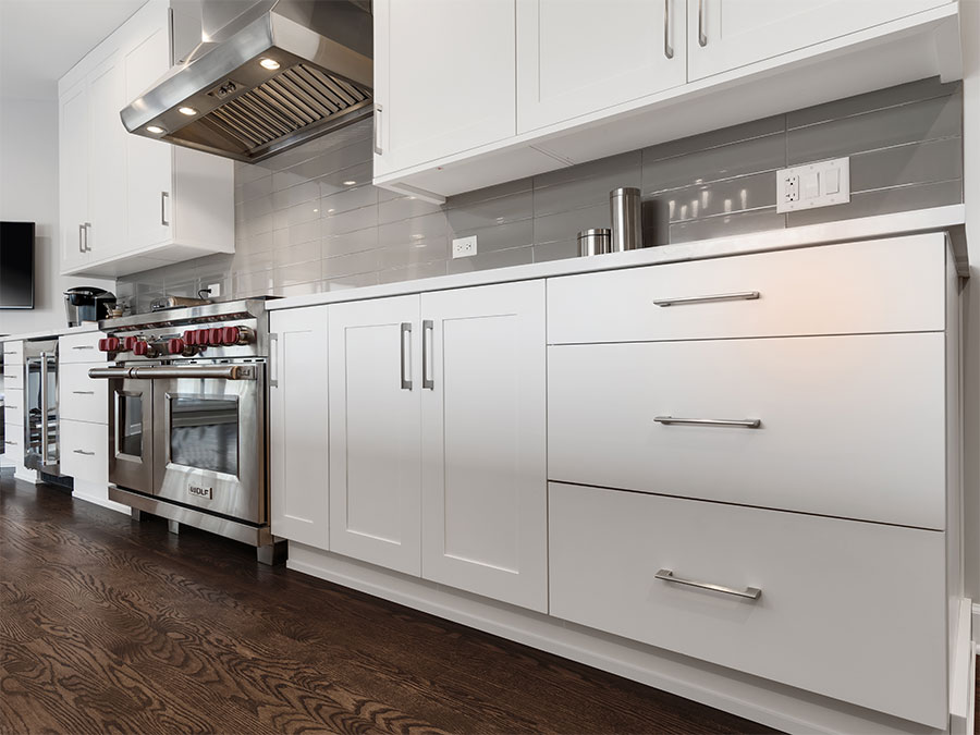 Drawers, cabinets and appliances along the wall in a kitchen