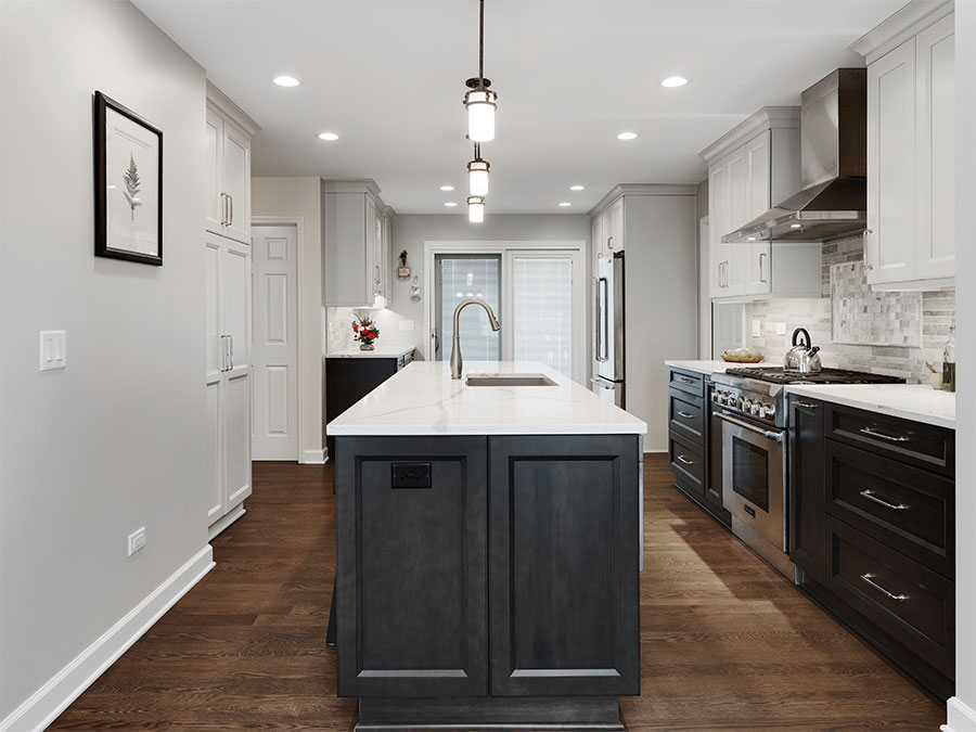 Modern kitchen with island, appliances, cabinets, drawers, and white polished stone countertops