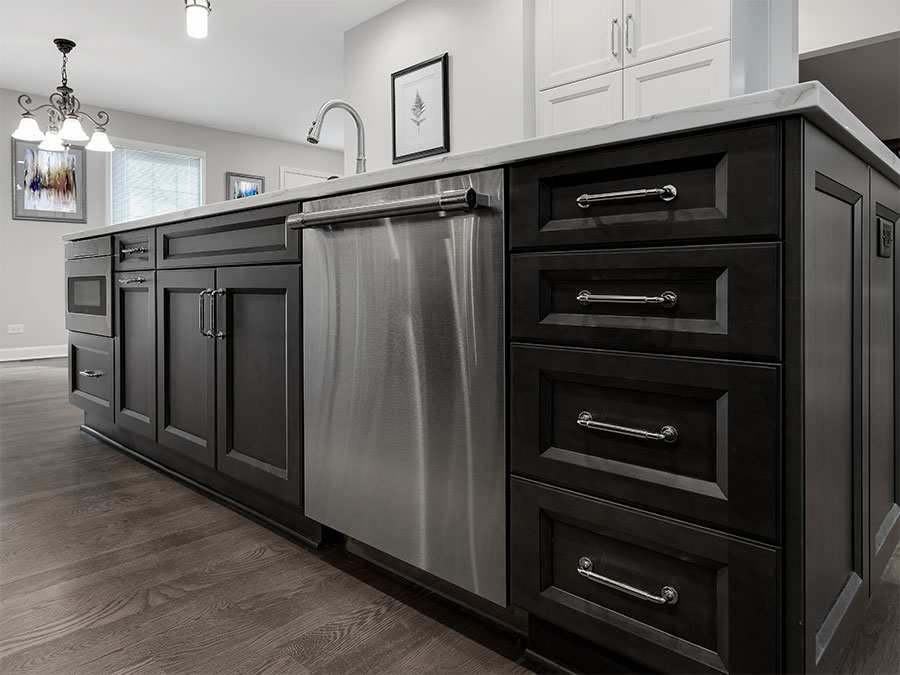 Modern kitchen island with cabinets, drawers, sink, dishwasher and small oven