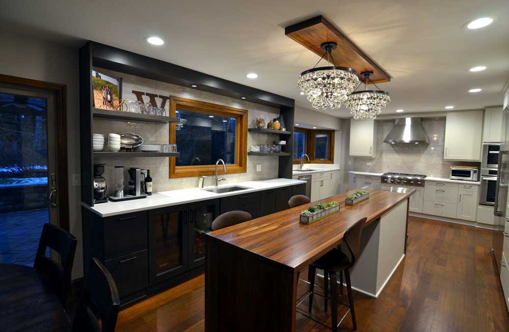 transitional galley kitchen remodel long oak wood island chandelier lighting black & white cabinets