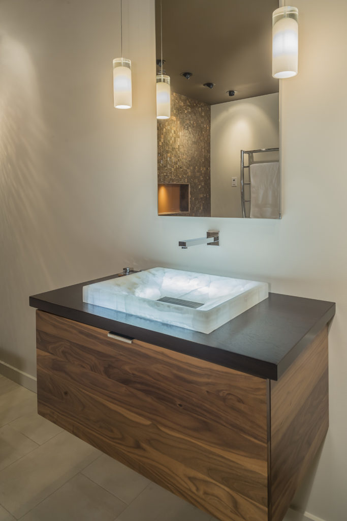 floating sink in remodele bathroom stone sink pendant lighting wood finish